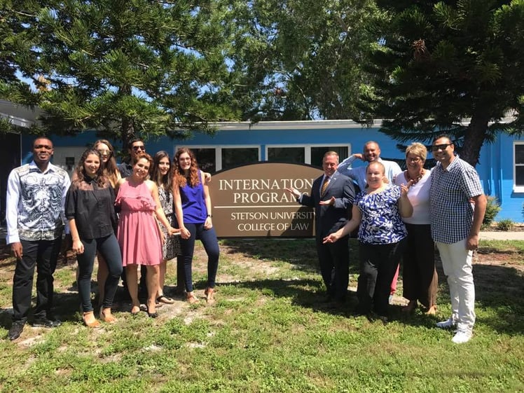 Nathaniel Ovabor gathers with international students, Stetson Law leadership, in front of the International Programs Office.