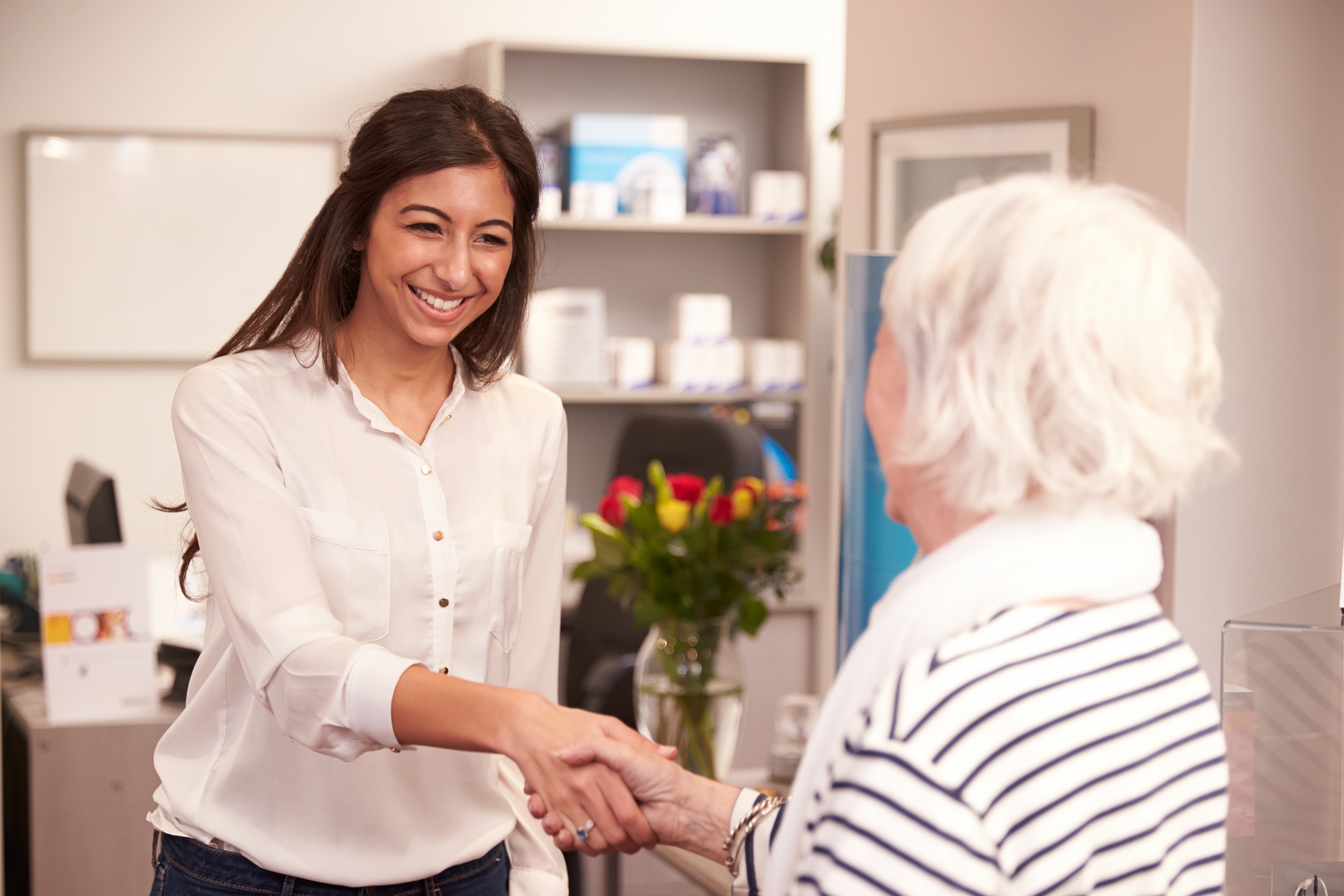 A-female-physician-greeting-an-elderly-woman-in-the-office-469218458_4319x2880