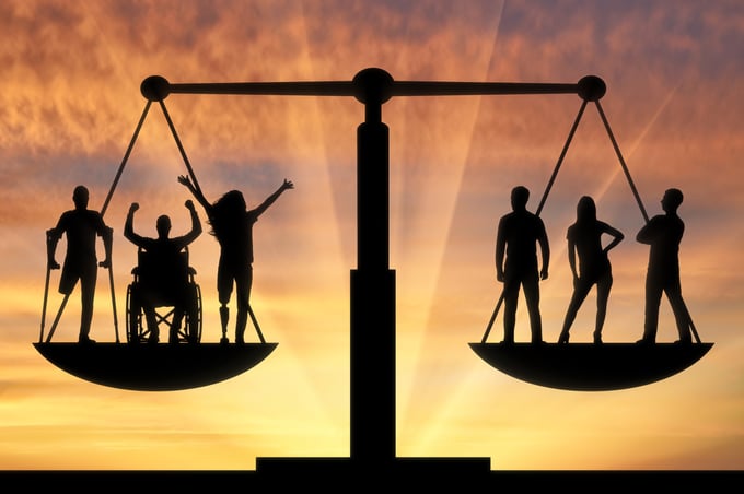 Balanced scales with one side having individuals with disabilities and the other side individuals without disabilities