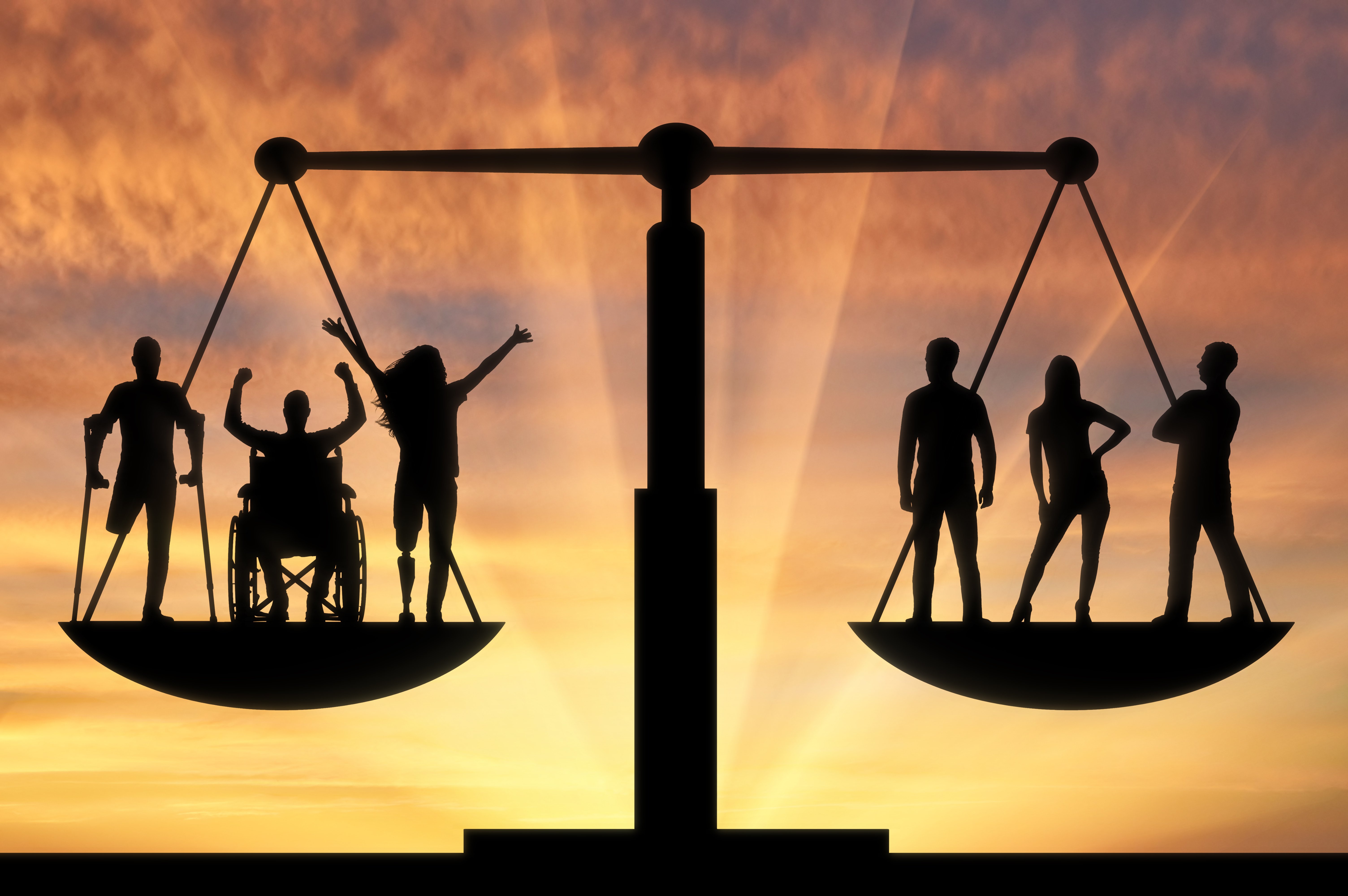 Balanced scales with one side having individuals with disabilities and the other side individuals without disabilities