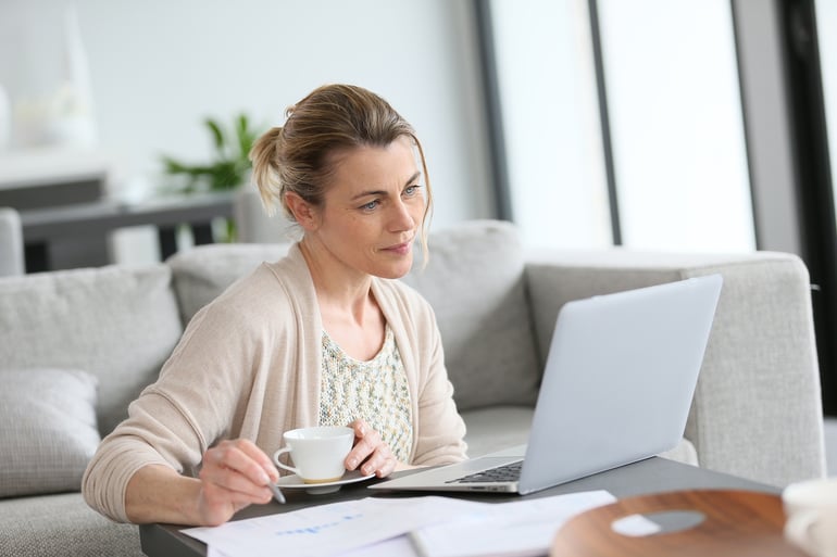 how to write a personal statement for llm woman with coffee working on laptop