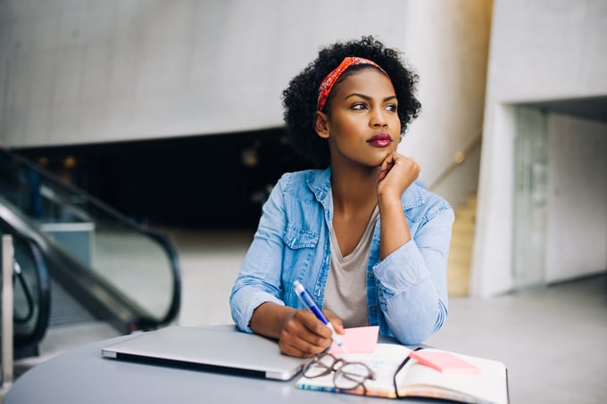 Woman with notebook and laptop