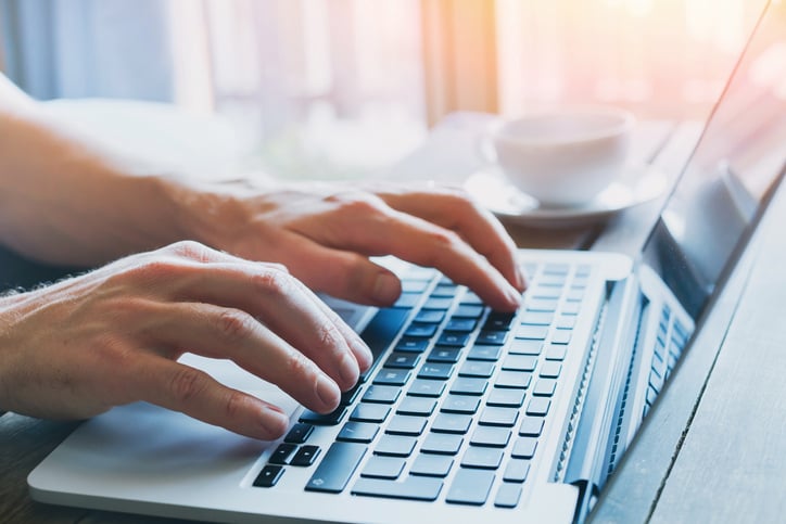 Closeup of a person typing their personal statement on a laptop